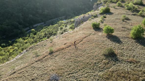 Woman Traveler in a Hat Walks on Top of a Mountain in Bakhchisarai