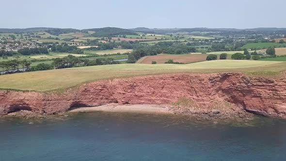 STATIC CROP aerial,ing toward red cliffs along the Jurassic Coast world heritage site