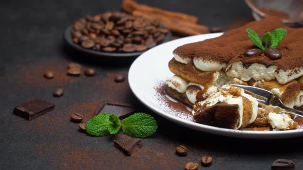 Portion of Classic Tiramisu Dessert on Ceramic Plate on Concrete Background