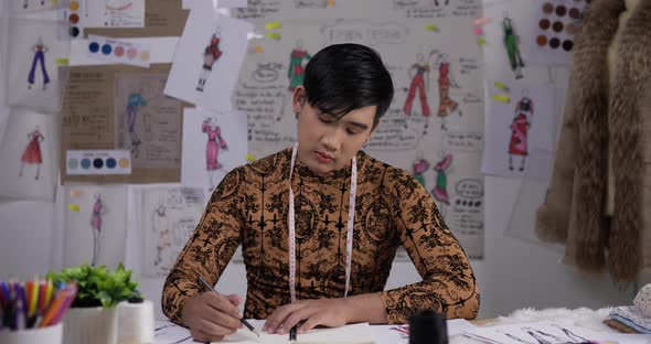 Fashion designer man draws a sketch clothing