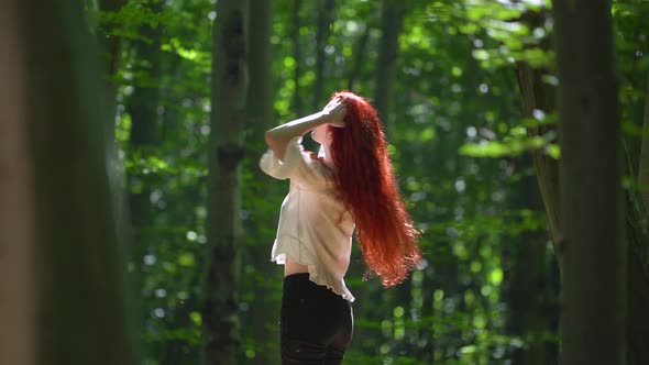 Girl with long red hair spinning around