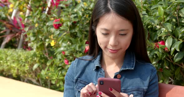 Woman use of mobile phone at outdoor park