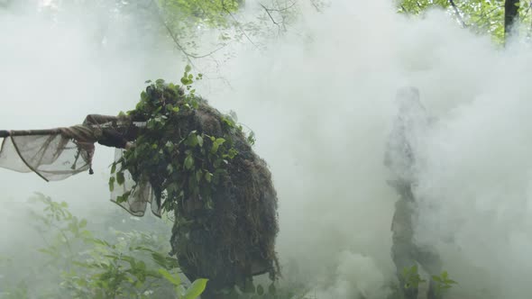 Soldiers Coming Out Under Cover of Smoke Cloud Spreading Out Forest