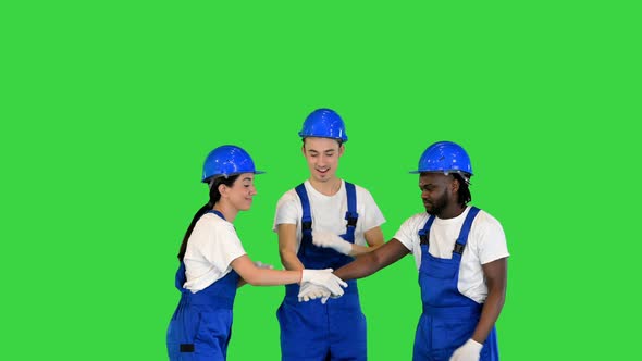 Group of Workers Put Hands on One Another and Rising Their Hands for Motivation on a Green Screen