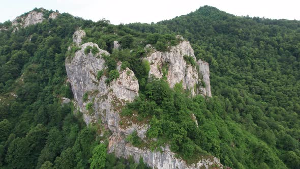 Approaching a large chunk of rock among the mountainous forest of Levinco, Asturias