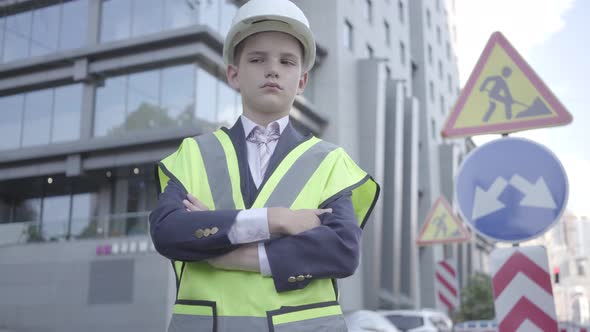 Portrait Cute Little Successful Boy Wearing Business Suit and Safety Equipment and Constructor