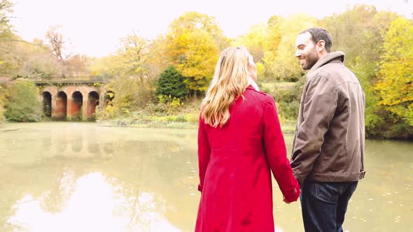 Happy couple hiking and enjoying a walk in the countryside wood with autumn f