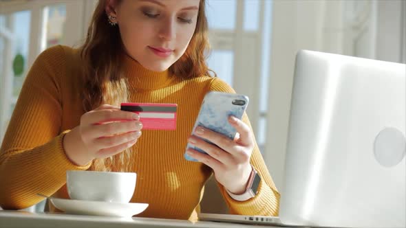 Beautiful Sunny Day Young Woman Drinks Morning Coffee in a Cafe, Making Online a Purchase Easy