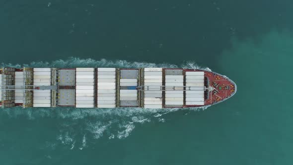 Large Cargo Ship with Containers in the Sea. Aerial Vertical Top-Down View