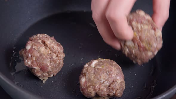 Italian Minced Pork Meatballs are Mixed with Ground Beef in a Frying Pan