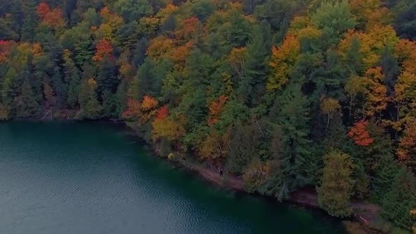 Majestic aerial shot of Pink Lake at Gatineau Park during the fall season.