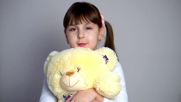 Portrait of Happy Caucasian Little Girl Hugging Teddy Bear