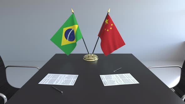 Flags of Brazil and China on the Table alt
