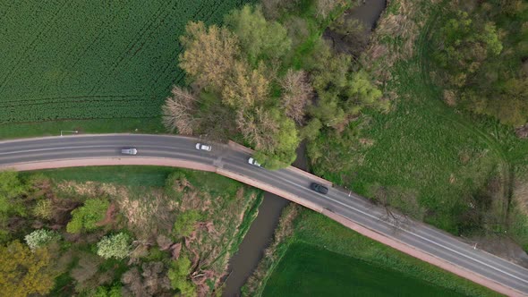 Car Driving on Road Among Agricultural Fields