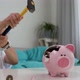Little child girl is crashing piggy bank with hammer in slow motion - VideoHive Item for Sale
