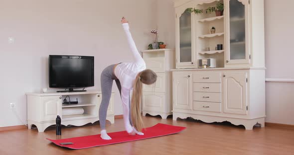 Girl doing warm-up torso twist exercise before practicing yoga. Healthy lifestyle concept