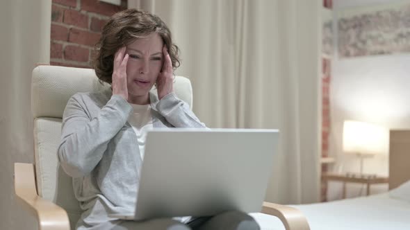 Hardworking Old Woman Having Headache on Sofa