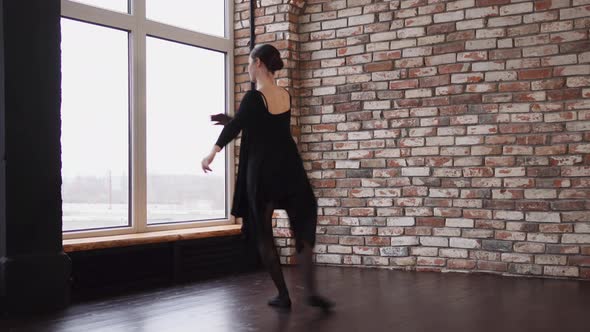 Modern Ballerina Is Dancing in a Loft Room Whirling