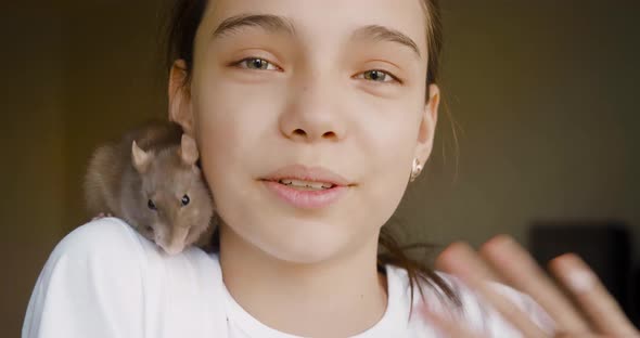 A Teenage Blogger Talks About His Pet a Domestic Rat During an Online Broadcast