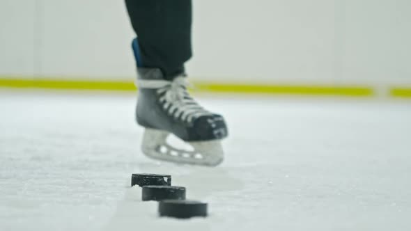 Unrecognizable Hockey Player Shooting Pucks