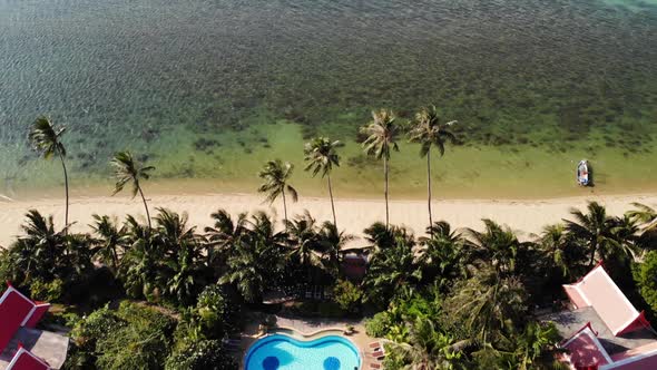 Oriental Houses on Seashore. Drone View of Lovely Oriental Cottages and Green Coconut Palms