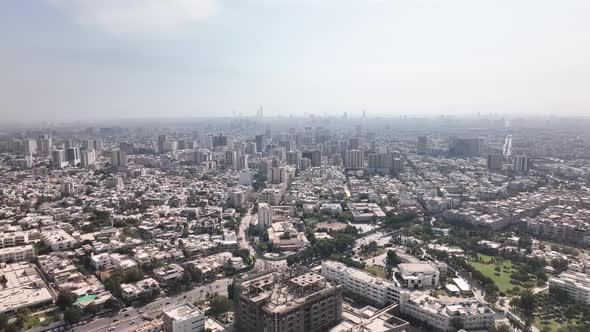 Aerial Flying Over Karachi City Skyline In Pakistan With Haze Seen In The Distance. Dolly Forward