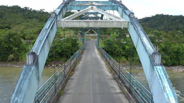 A metal truss bridge, driving over the bridge while the sun comes out