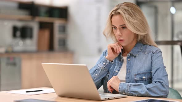 Young Casual Woman with Laptop Thinking at Work 