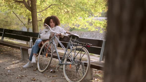 Thoughtful black woman reading book in park