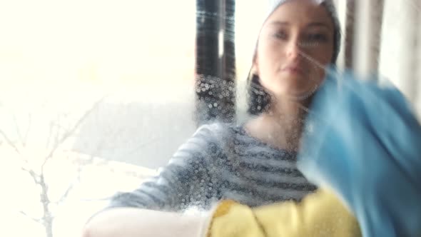 Woman Clean the Window with Rag and Spray