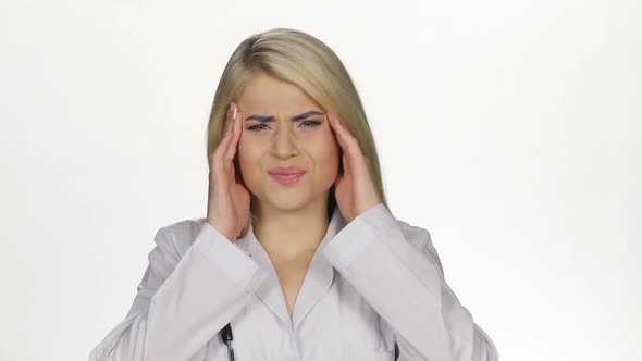 Young Female Doctor Having Headache. White