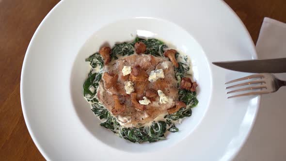 Turkey steak with spinach and chanterelle mushrooms