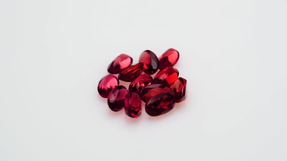 Natural Red Garnet Gemstone on the White Background on the Turning Table