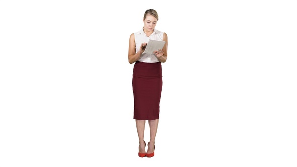 Attractive businesswoman using a digital tablet while standing