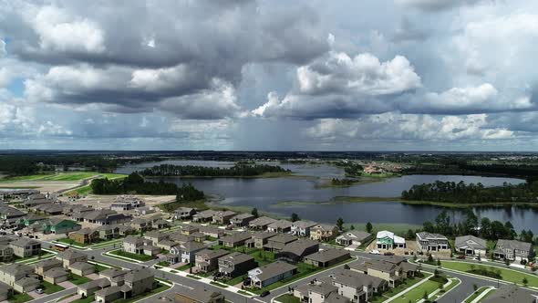 Aerial view of an upper middle class lakefront neighborhood subdivision with single family homes and