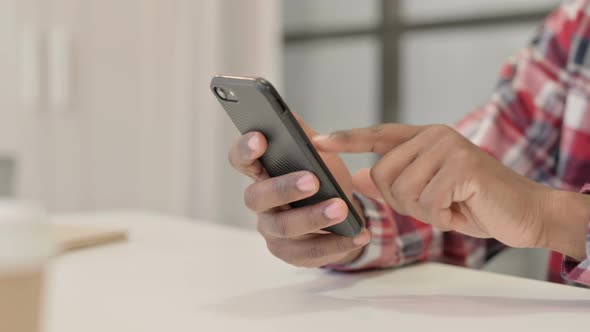 Close Up of African Man Using Smartphone