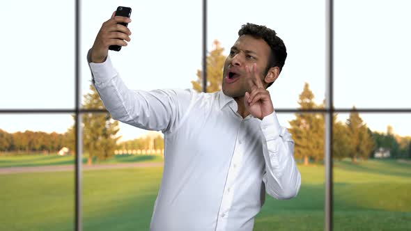 Cheerful Indian Businessman Taking Selfie with Smartphone.