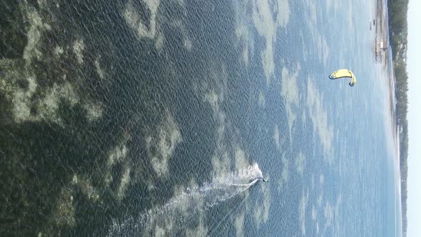 Vertical Video Kitesurfing Near the Shore of Zanzibar Tanzania Aerial View