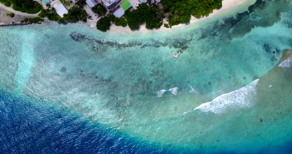 Natural overhead island view of a white paradise beach and aqua blue water background in hi res 4K