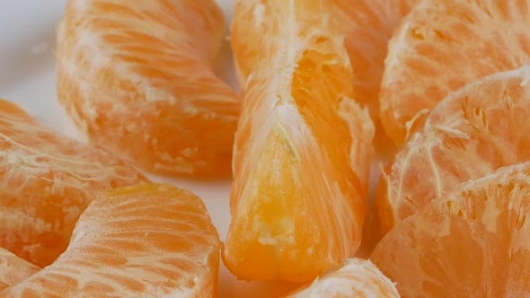 Tangerines or mandarin orange fruits and peeled segment.
