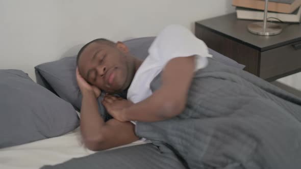 African Man Sleeping in Bed Peacefully