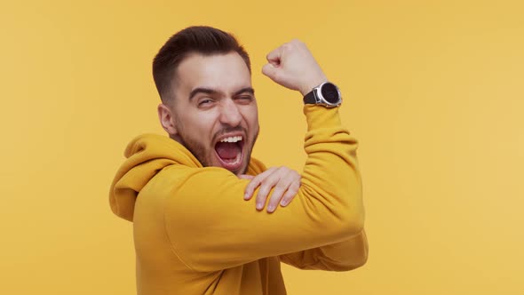 Expressive young man screaming and shouting over vibrant background.