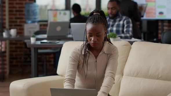 African American Worker Analyzing Business Charts