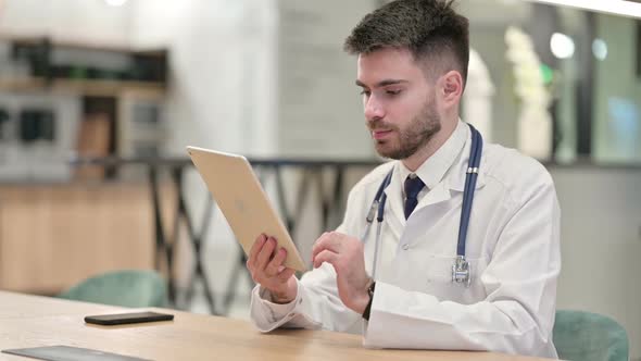 Young Doctor Using Tablet in Office