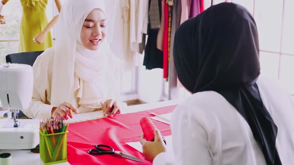 Muslim women fashion designers are in process of creating new clothes collection.