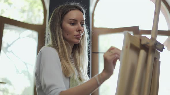 Concentrated Woman Drawing a Picture at Art Studio