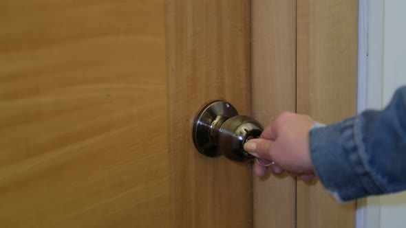 Woman Using a Key to Open the Lock of the Front Door