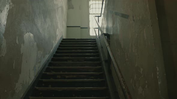 Ascending crane shot of old interior stairs at Alcatraz Prison