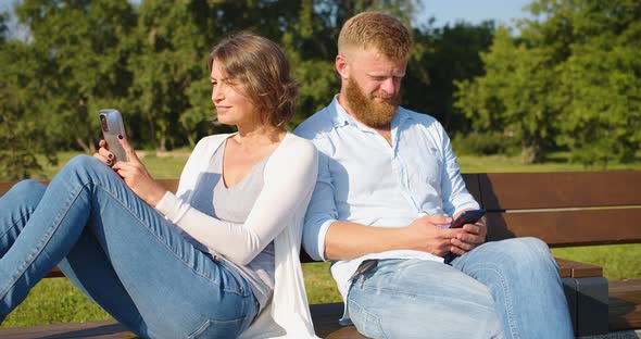 Psychology of Family Relationships a Middleaged Couple Sits Buried in Smartphones and Ignores Each