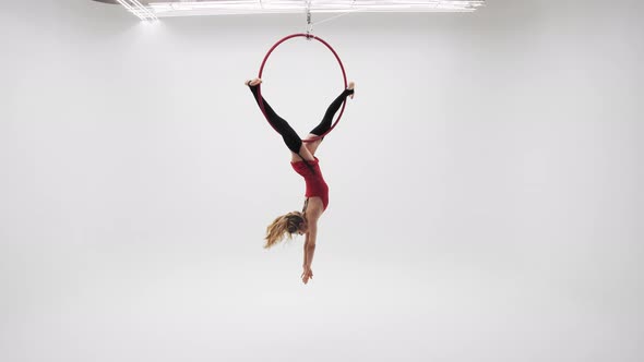 Girl In A Red Dress Spinning Upside Down On The Air Ring